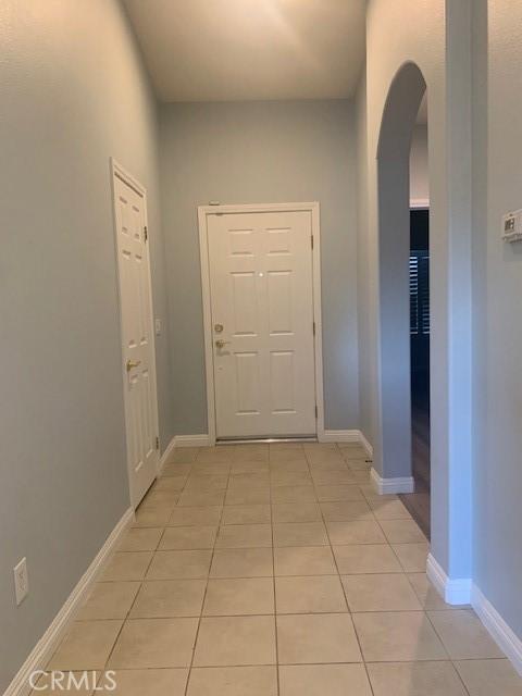 corridor with light tile patterned floors