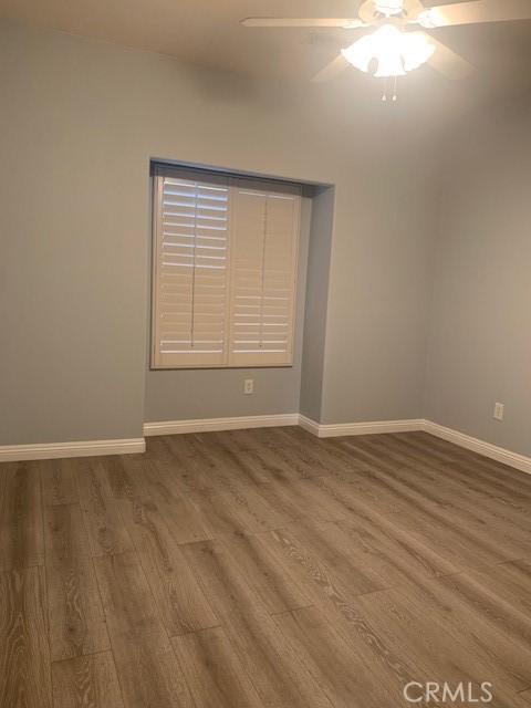 spare room featuring ceiling fan and hardwood / wood-style floors