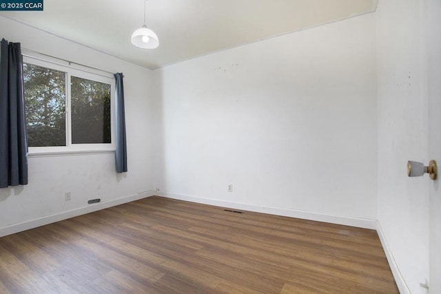 unfurnished room featuring dark hardwood / wood-style flooring