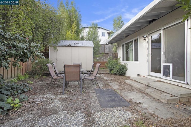 view of patio / terrace with a shed