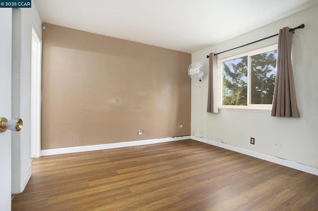 spare room with hardwood / wood-style flooring