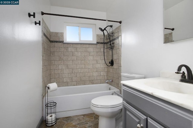 full bathroom featuring toilet, vanity, and tiled shower / bath combo