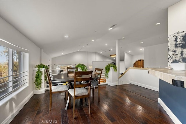 dining room with dark hardwood / wood-style floors and vaulted ceiling