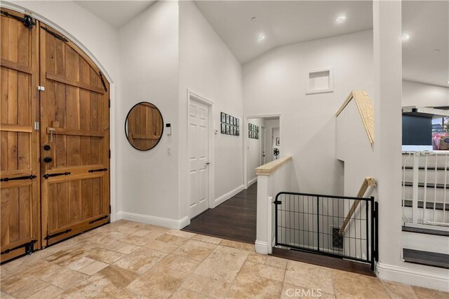 entryway featuring high vaulted ceiling