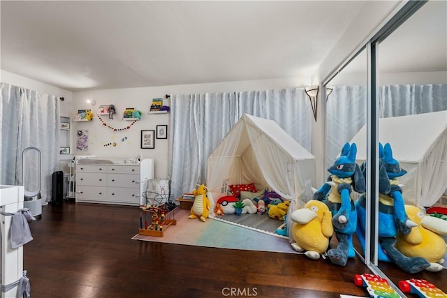 playroom with dark hardwood / wood-style flooring