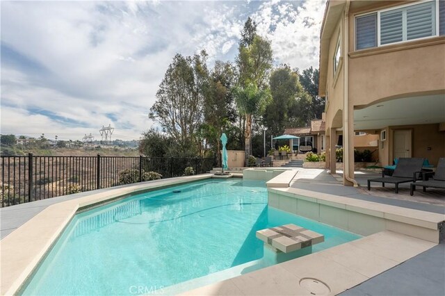 view of swimming pool featuring a patio