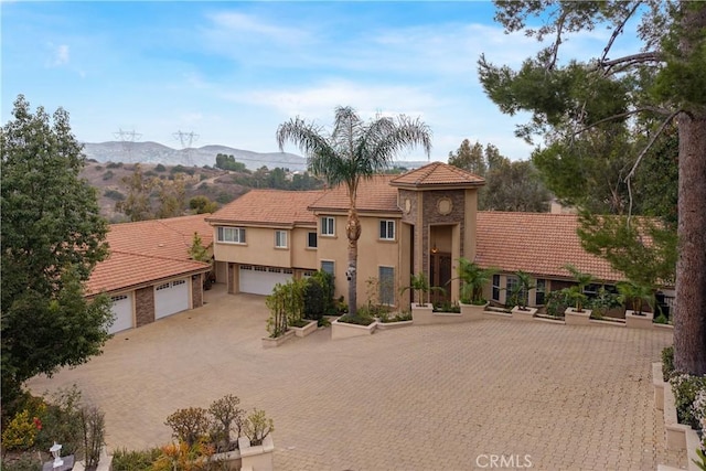 mediterranean / spanish house with a mountain view and a garage