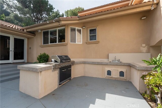 view of patio / terrace with exterior kitchen and french doors