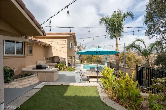 view of yard with a patio, a fenced in pool, and area for grilling