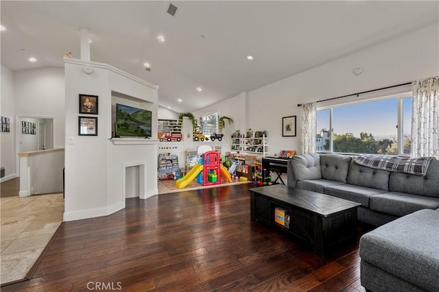 living room with hardwood / wood-style flooring and high vaulted ceiling