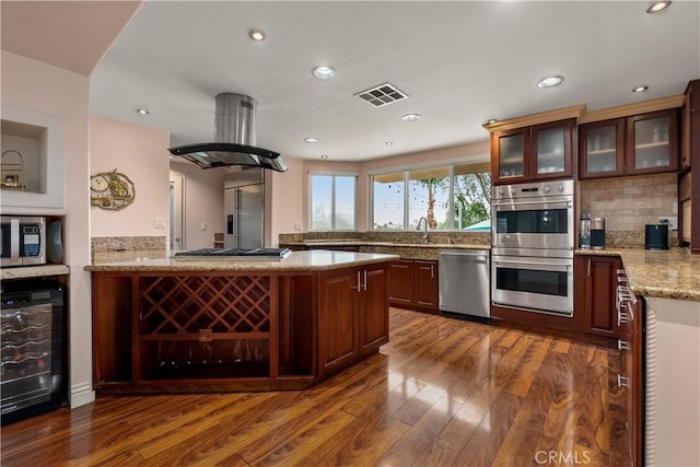 kitchen with beverage cooler, stainless steel appliances, backsplash, dark hardwood / wood-style floors, and island range hood