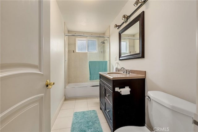 full bathroom featuring toilet, tile patterned floors, vanity, and enclosed tub / shower combo