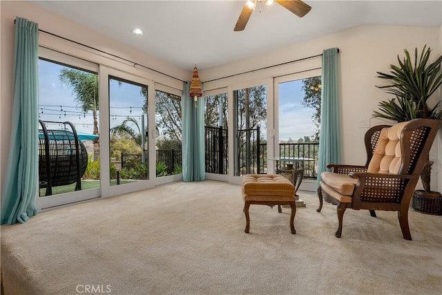 sitting room with ceiling fan, light colored carpet, and a wealth of natural light