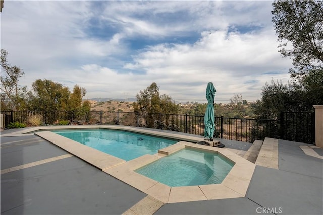 view of swimming pool with an in ground hot tub, a mountain view, and a patio