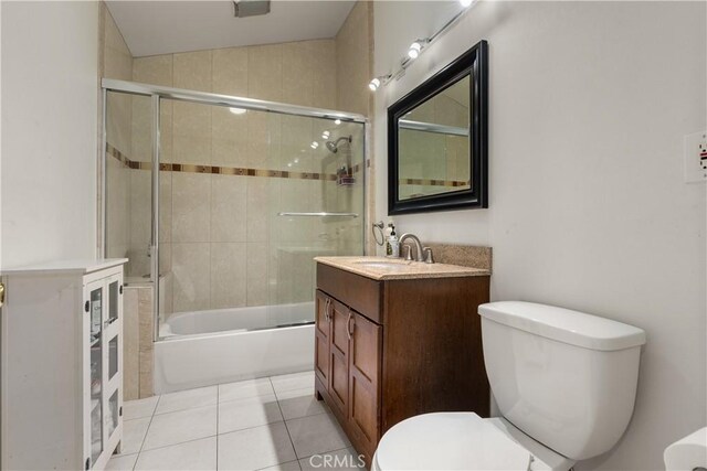 full bathroom with toilet, enclosed tub / shower combo, tile patterned flooring, vaulted ceiling, and vanity