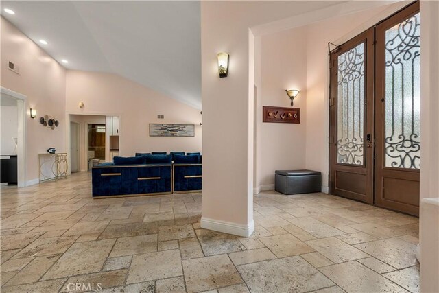 foyer with high vaulted ceiling and french doors