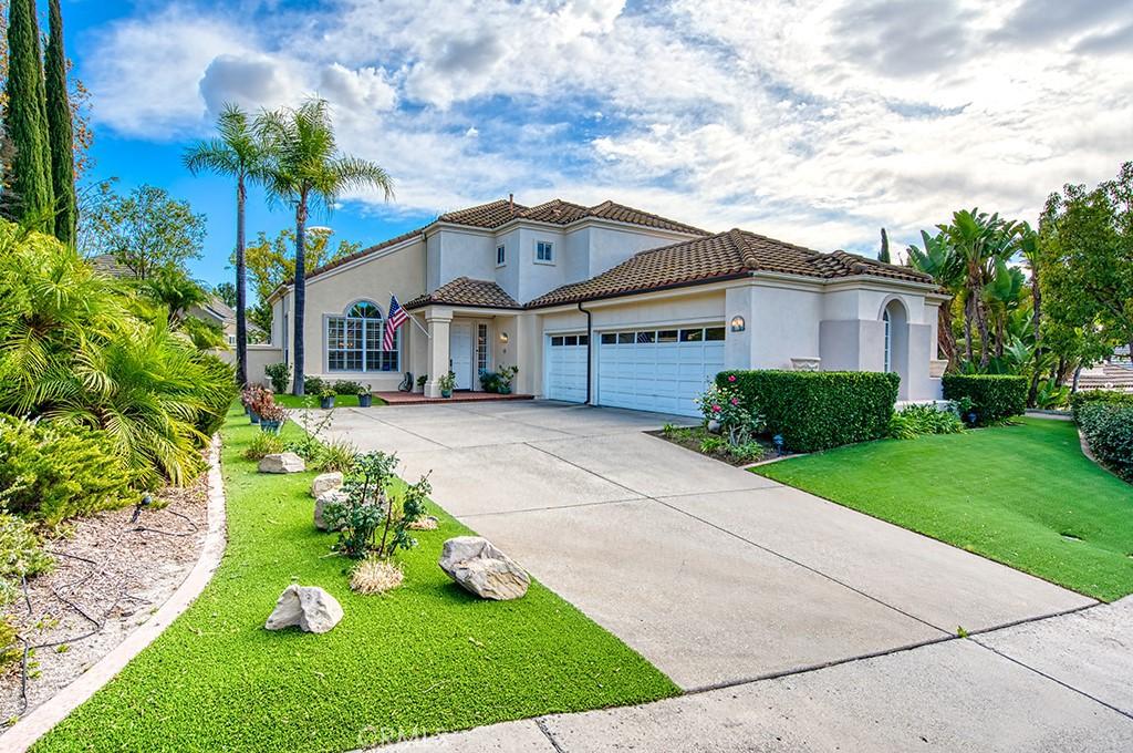 mediterranean / spanish home featuring a front yard and a garage