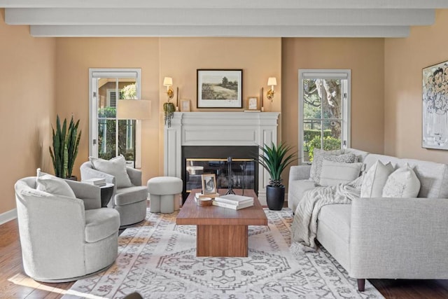 living room with beam ceiling and light hardwood / wood-style floors