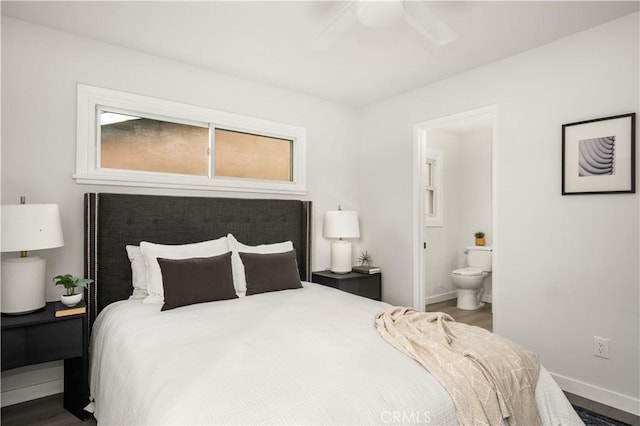 bedroom featuring ensuite bath, ceiling fan, multiple windows, and wood-type flooring