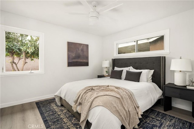 bedroom featuring ceiling fan and dark hardwood / wood-style flooring