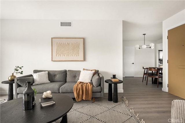 living room with an inviting chandelier and hardwood / wood-style floors