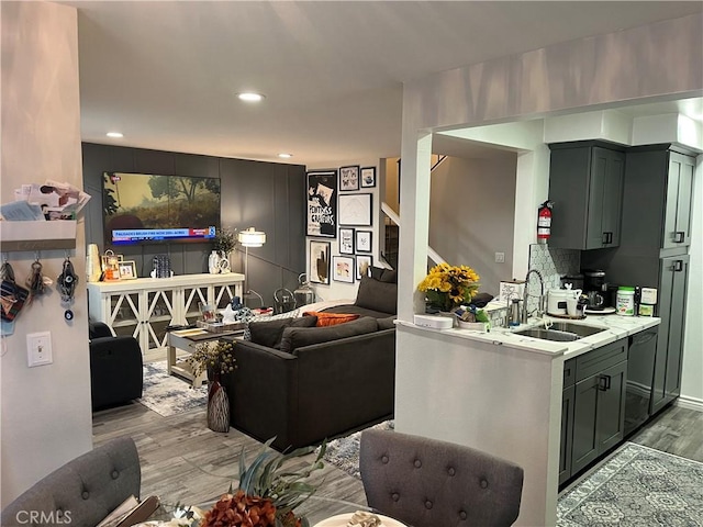 living room with sink and light hardwood / wood-style floors