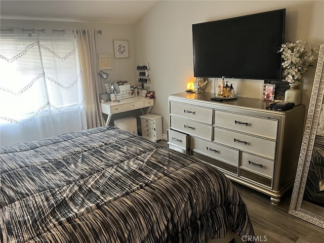 bedroom with dark hardwood / wood-style flooring