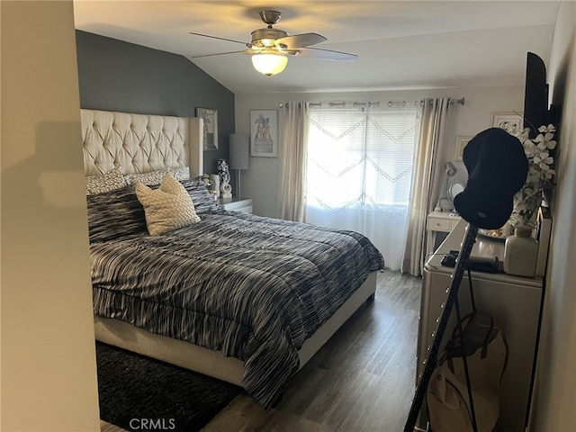 bedroom featuring vaulted ceiling, dark hardwood / wood-style floors, and ceiling fan