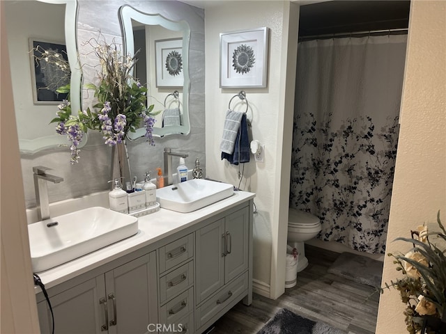 bathroom featuring hardwood / wood-style flooring, vanity, and toilet