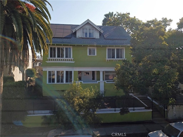 view of front of property with solar panels