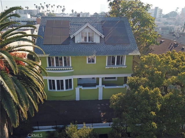 back of house with solar panels