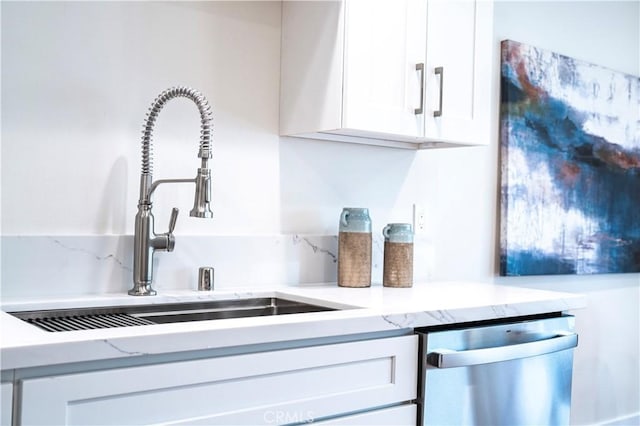 interior space with sink, white cabinets, and stainless steel dishwasher