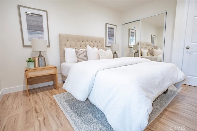 bedroom featuring light wood-type flooring and a closet