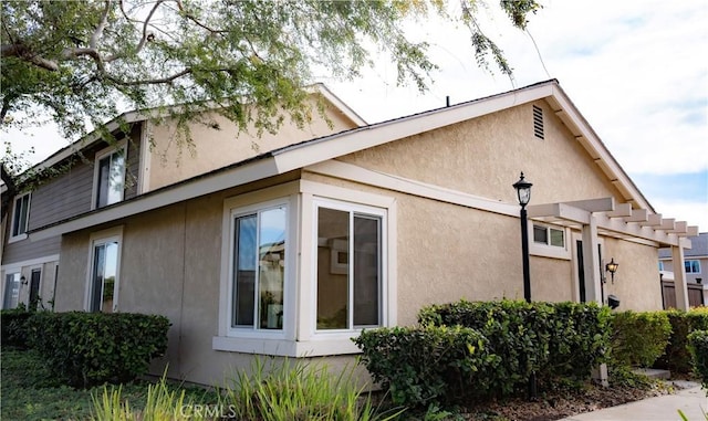 view of side of home featuring a pergola