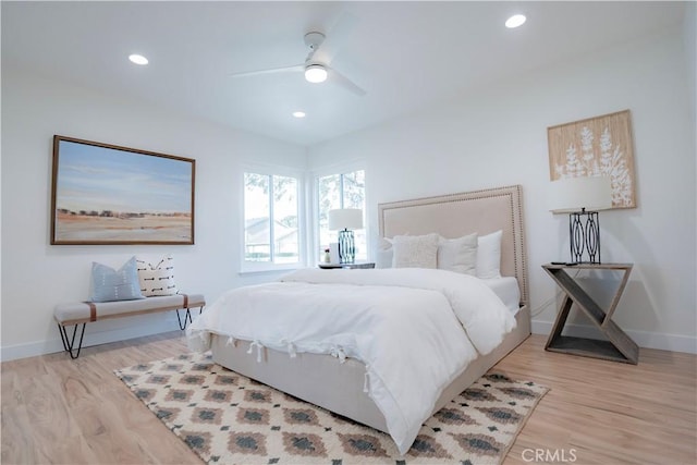 bedroom with ceiling fan and light hardwood / wood-style floors