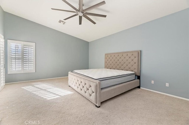 bedroom with lofted ceiling, light carpet, a ceiling fan, visible vents, and baseboards