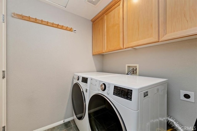 laundry area with visible vents, independent washer and dryer, cabinet space, and baseboards