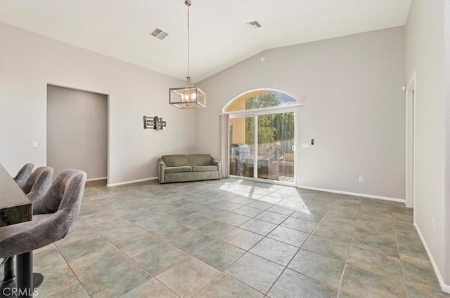 interior space with visible vents, vaulted ceiling, a notable chandelier, and light tile patterned flooring