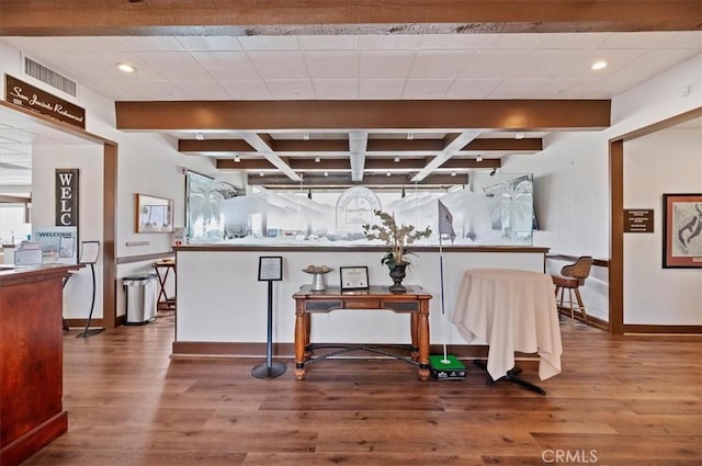 bar featuring beamed ceiling, wood finished floors, visible vents, and baseboards