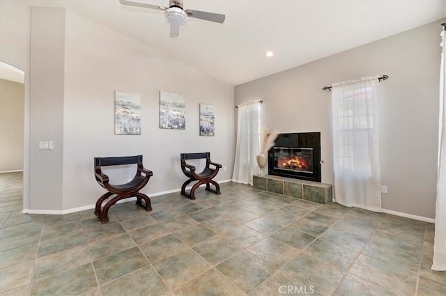 living area with arched walkways, baseboards, ceiling fan, a fireplace, and recessed lighting