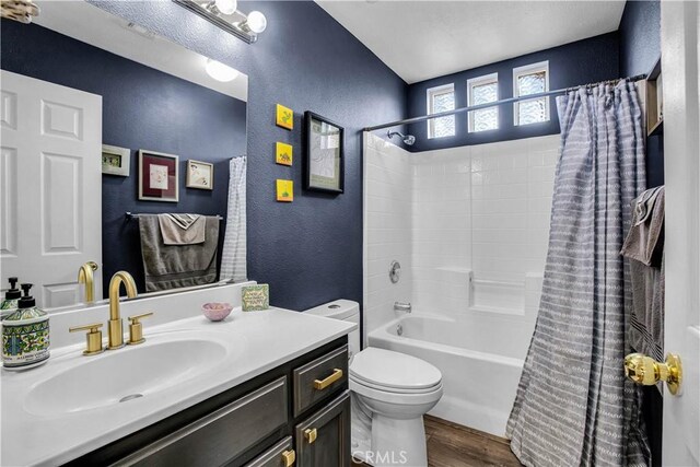 full bathroom featuring toilet, hardwood / wood-style flooring, vanity, and shower / bath combo with shower curtain