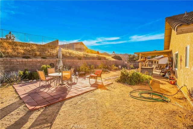 view of yard featuring a mountain view and a patio