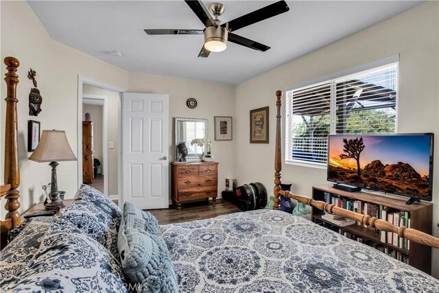 bedroom with ceiling fan and dark hardwood / wood-style floors