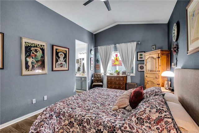 bedroom featuring ceiling fan, hardwood / wood-style flooring, ensuite bath, and vaulted ceiling