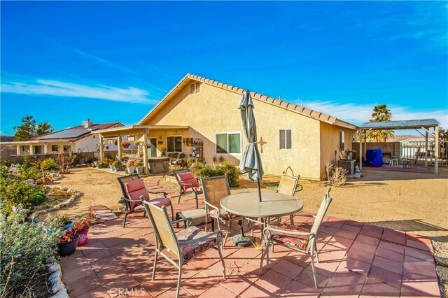 view of patio with central AC and a pergola