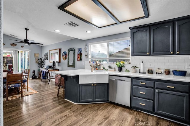 kitchen featuring ceiling fan, backsplash, dishwasher, wood-type flooring, and sink