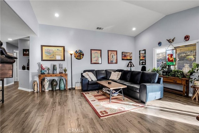 living room featuring lofted ceiling and wood-type flooring