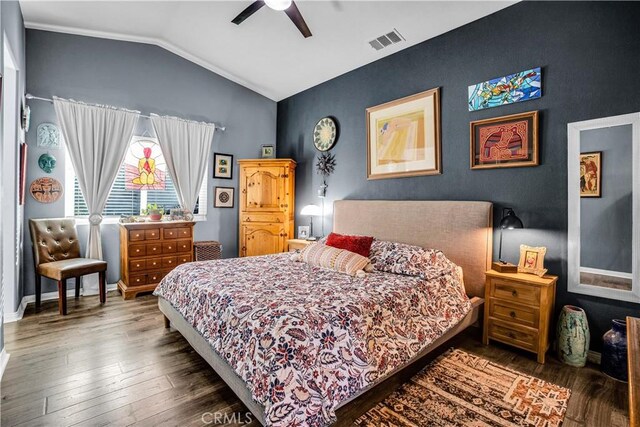 bedroom featuring ceiling fan, dark wood-type flooring, and lofted ceiling