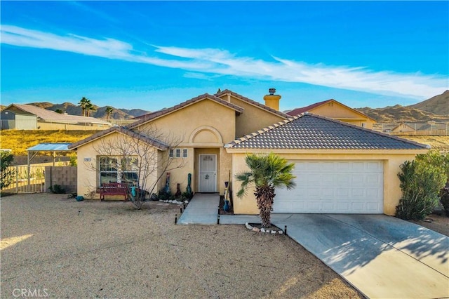 view of front of property with a garage and a mountain view