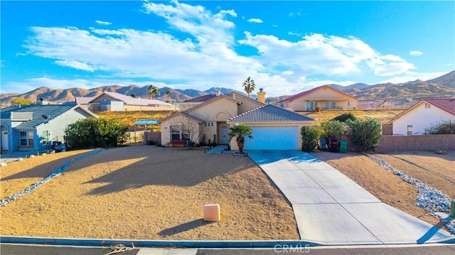 view of front of property with a mountain view and a garage